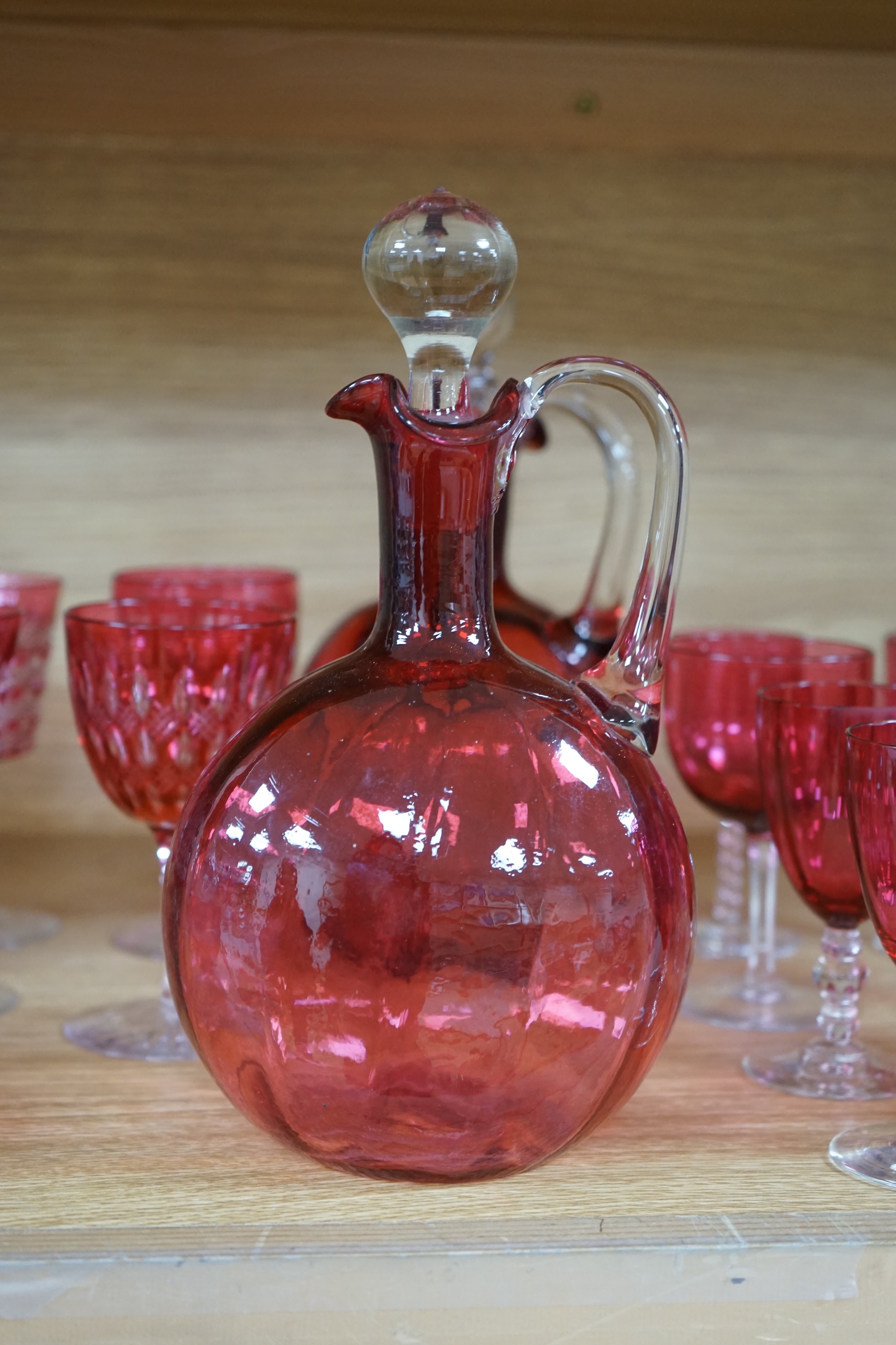 Two cranberry glass liqueur decanters and a collection of various glasses and a bowl, decanters 25cm high. Condition - good